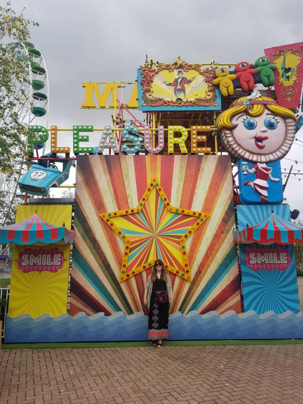 girl stood in front of wooden decorative star