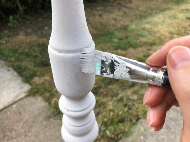 small paint brush painting plant stand leg light grey