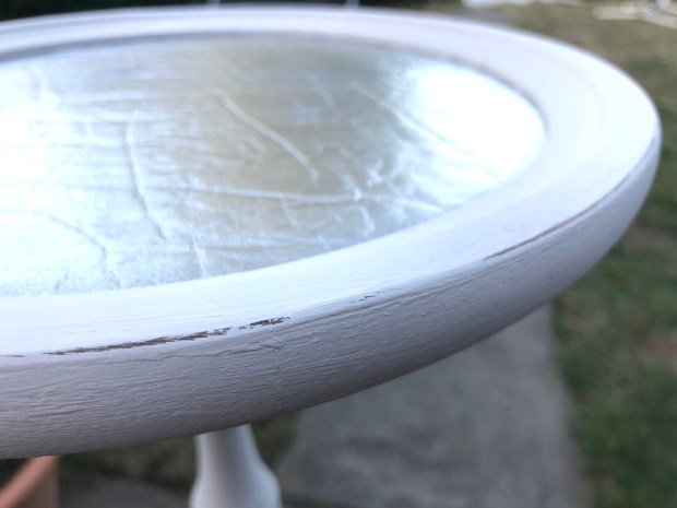 close up of plant stand with silver leather centre and light grey edges