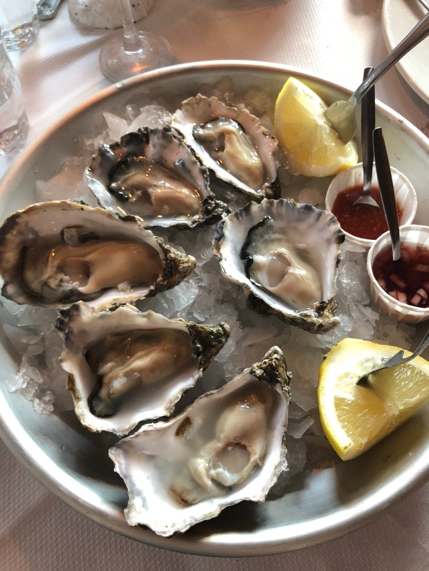 a plate of whitstable oysters with lemon