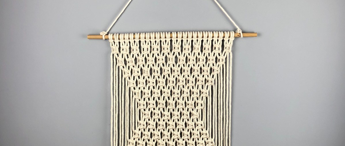 Macramé wall hanging on grey wall